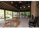 Covered pavilion with picnic tables, rocking chairs, and a brick fireplace at 4008 Flatiron Dr, Charleston, SC 29414
