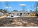 Spacious backyard with a patio, fire pit, swing, and barbecue grills, perfect for outdoor gatherings at 402 Woodward Blvd, Summerville, SC 29483