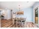 Bright dining room featuring stylish light fixture, wood floors, and sliding glass doors at 402 Woodward Blvd, Summerville, SC 29483