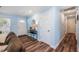 Inviting entryway features light blue walls, wood floors, and decorative mirror and table at 402 Woodward Blvd, Summerville, SC 29483
