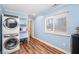 Well-organized laundry room featuring a stacked washer/dryer and storage shelves at 402 Woodward Blvd, Summerville, SC 29483