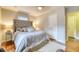 Bedroom featuring a large bed with a tufted headboard, soft linens, and hardwood floors at 406 Annette Dr, Goose Creek, SC 29445