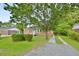 Charming brick home with a lush, green front yard and mature tree at 406 Annette Dr, Goose Creek, SC 29445