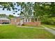 Well-maintained brick home with a green lawn and charming front entrance at 406 Annette Dr, Goose Creek, SC 29445