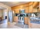 Well-lit kitchen featuring wooden cabinets, stainless steel appliances, and ample counter space at 406 Annette Dr, Goose Creek, SC 29445