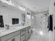Modern bathroom features double vanity, marble floors, and glass enclosed shower in neutral tones at 4414 Avery Ave, North Charleston, SC 29405