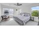 Bright bedroom with a metal frame bed, light gray carpet, and large windows offering great natural light at 4414 Avery Ave, North Charleston, SC 29405