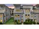 Stylish townhome boasts a welcoming entrance, well-lit windows, and manicured lawn at 4414 Avery Ave, North Charleston, SC 29405