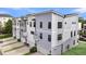 New townhomes with modern gray and white siding and individual garages with driveways at 4414 Avery Ave, North Charleston, SC 29405