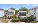 Two new homes with modern exteriors, balconies, landscaped front yards, and lime-green door at 4414 Avery Ave, North Charleston, SC 29405