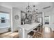 Open kitchen boasts bar stool seating, pendant lighting, and stainless steel refrigerator at 4414 Avery Ave, North Charleston, SC 29405
