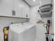 Functional laundry room featuring a washer, dryer, storage cabinets, and convenient shelving at 4414 Avery Ave, North Charleston, SC 29405