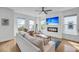Bright living room features hardwood floors, modern fireplace, and ample natural light from multiple windows at 4414 Avery Ave, North Charleston, SC 29405