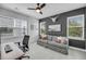 Inviting office features a ceiling fan, desk, sofa, and natural light from multiple windows at 4414 Avery Ave, North Charleston, SC 29405