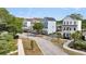 Street view of new modern homes with colorful exteriors, porches, and green landscaped yards at 4414 Avery Ave, North Charleston, SC 29405