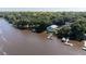 Aerial view of waterfront home with private dock and beautifully landscaped surroundings at 4940 Lambs Road Rd, North Charleston, SC 29418