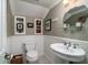 Elegant bathroom with white wainscoting, floating sink, decorative mirror, and built-in shelves at 4940 Lambs Road Rd, North Charleston, SC 29418