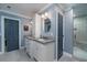 Bathroom featuring dual sinks with granite counters, white cabinets, and a glass-enclosed shower with tiled floors at 4940 Lambs Road Rd, North Charleston, SC 29418