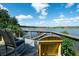 Cozy deck with chairs overlooking calm water with lush greenery in the background at 4940 Lambs Road Rd, North Charleston, SC 29418