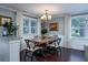 Dining room with hardwood floors, large windows, and modern chandelier at 4940 Lambs Road Rd, North Charleston, SC 29418