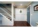 Inviting entryway with stairs, a coat rack, white paneling, and dark hardwood floors at 4940 Lambs Road Rd, North Charleston, SC 29418