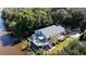 Stunning elevated coastal home with a deck, manicured lawn, and lush surrounding landscape at 4940 Lambs Road Rd, North Charleston, SC 29418