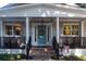 Charming front porch with brick stairs, columns, and a blue front door at 4940 Lambs Road Rd, North Charleston, SC 29418