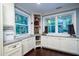 Bright kitchen with granite countertops, lots of windows, and white cabinetry at 4940 Lambs Road Rd, North Charleston, SC 29418