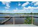 Picturesque water view from the deck, featuring a dock, beautiful flowers, and lush greenery at 4940 Lambs Road Rd, North Charleston, SC 29418