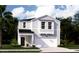 Charming two-story home with light gray siding, lush landscaping, and an attached two-car garage at 501 Kitsap Ct, Summerville, SC 29486
