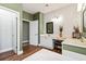 Bathroom featuring a soaking tub, vanity with dual sinks, and stylish wallpaper at 5413 Barnsley Dr, North Charleston, SC 29420