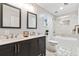 Bright bathroom featuring a double sink vanity, framed mirrors, tile floors, and a glass-enclosed shower at 5413 Barnsley Dr, North Charleston, SC 29420