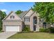 Charming two-story brick home with a well-manicured lawn and attached two-car garage at 5413 Barnsley Dr, North Charleston, SC 29420