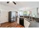 Bright kitchen with stainless steel appliances, hardwood floors, and adjacent dining area at 5413 Barnsley Dr, North Charleston, SC 29420