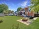 Spacious backyard featuring a fire pit, a lawn and a two-story red brick home at 5505 Indigo Makers Trce, Charleston, SC 29418