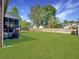Expansive backyard featuring a large lawn, wood fence and brick house at 5505 Indigo Makers Trce, Charleston, SC 29418