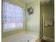 Bathroom featuring a large soaking tub, shower, floral curtain and wreath wall decor at 5505 Indigo Makers Trce, Charleston, SC 29418