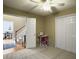 Carpeted bedroom has an open door view of the landing area with stairs and dining room at 5505 Indigo Makers Trce, Charleston, SC 29418