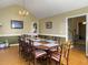 Dining room featuring ten seating, hardwood flooring, and a chandelier, and adjoining rooms at 5505 Indigo Makers Trce, Charleston, SC 29418