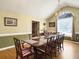 Well-lit dining room featuring ten seating, hardwood flooring, chandelier, and windows at 5505 Indigo Makers Trce, Charleston, SC 29418