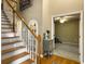 Inviting foyer features hardwood floors, staircase, and an archway leading to a carpeted living space at 5505 Indigo Makers Trce, Charleston, SC 29418