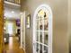 Hallway featuring an archway with a glass display case, leading to the living and dining areas at 5505 Indigo Makers Trce, Charleston, SC 29418