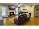 Cozy living room featuring a fireplace, ceiling fan, hardwood floors and access to the outdoors at 5505 Indigo Makers Trce, Charleston, SC 29418