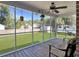 Screened in patio featuring a ceiling fan and a view of a well-manicured lawn at 5505 Indigo Makers Trce, Charleston, SC 29418