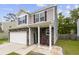 Inviting home entrance with decorative stone, chairs on the front porch, and a well-maintained lawn at 558 Wynfield Forest Dr, Summerville, SC 29485