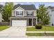 Charming two-story home featuring stone accents, a two-car garage, and a well-manicured front yard at 558 Wynfield Forest Dr, Summerville, SC 29485