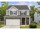 Charming two-story home featuring stone accents and a two-car garage, set against a blue sky at 558 Wynfield Forest Dr, Summerville, SC 29485