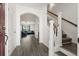 Bright foyer featuring hardwood floors, a staircase with white railings, and an archway leading to the living area at 558 Wynfield Forest Dr, Summerville, SC 29485