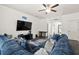 Comfortable living room featuring a large blue sectional sofa, modern decor, and ample natural light at 558 Wynfield Forest Dr, Summerville, SC 29485