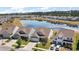 Aerial view of the houses and pond with trees and vegetation surrounding the neighborhood at 629 Snow Owl Dr, Summerville, SC 29486